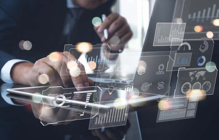 Business professional analyzing data dashboards on a tablet and laptop, symbolizing data-driven insights and performance results from integrated business operations.